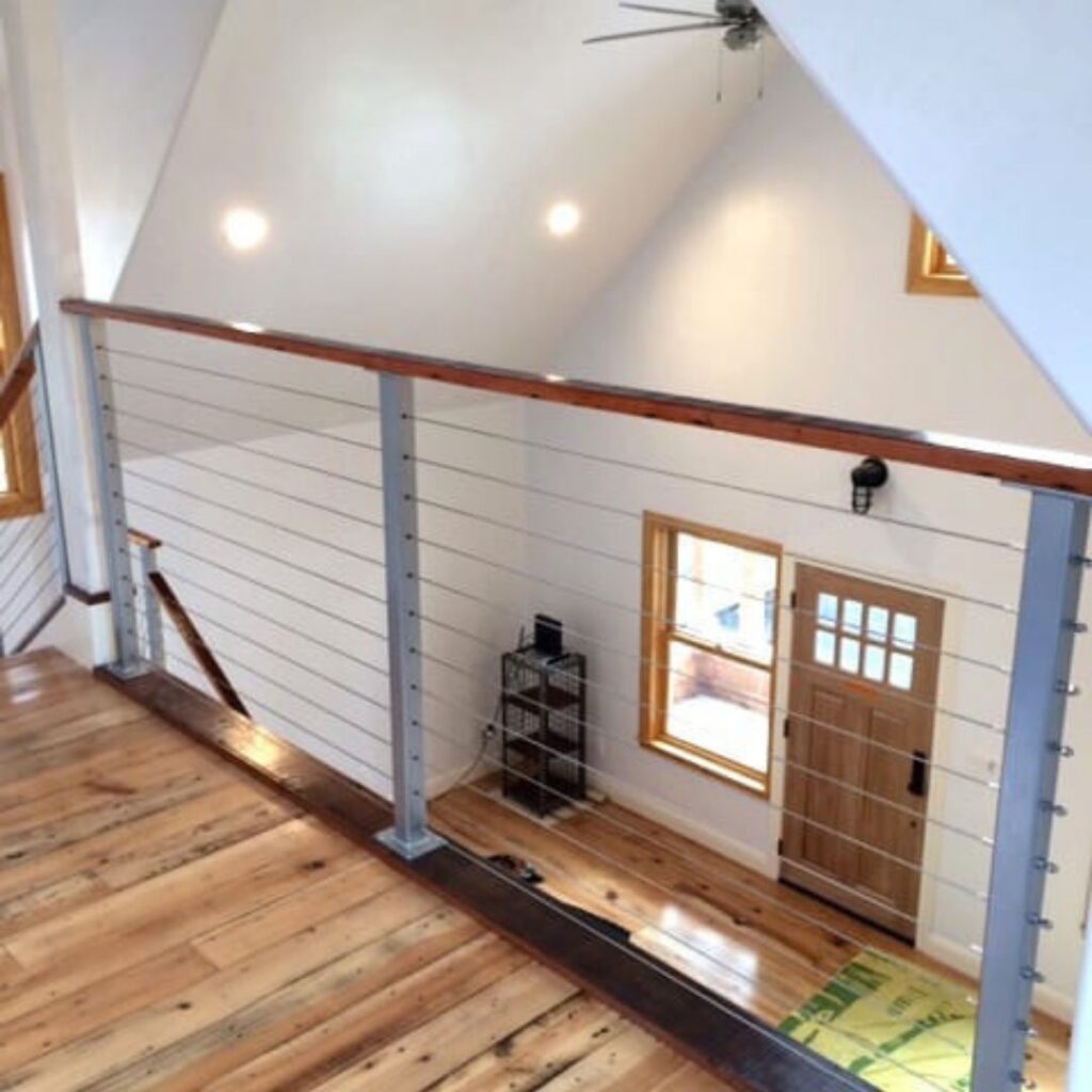 stainless steel cable railing overlooking first level in home