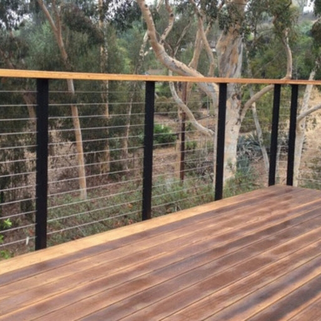 cable railing with a wood top and metal poles